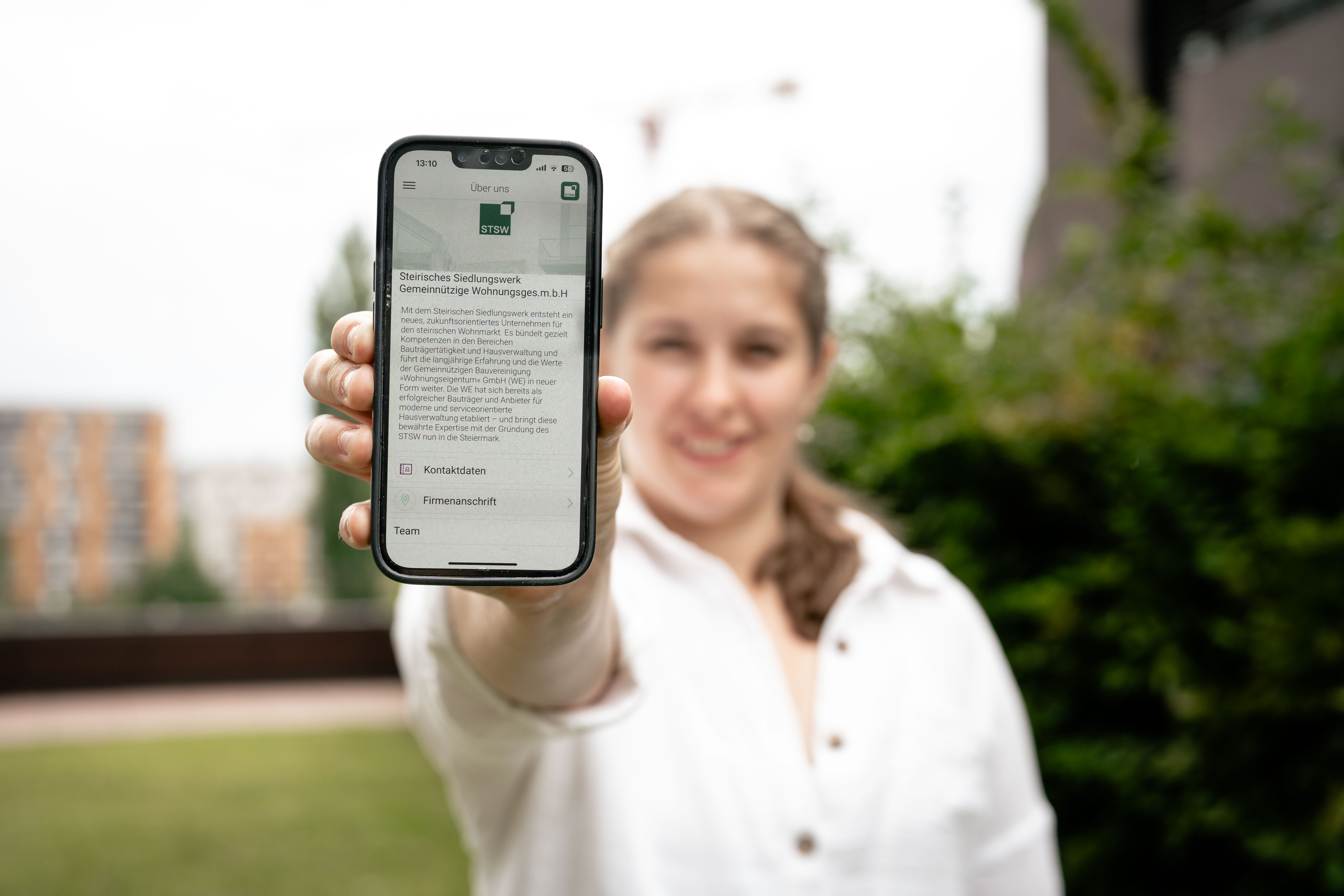 STSW-App_01 @ Fabian Hasler Frau hält Smartphone mit STSW App
